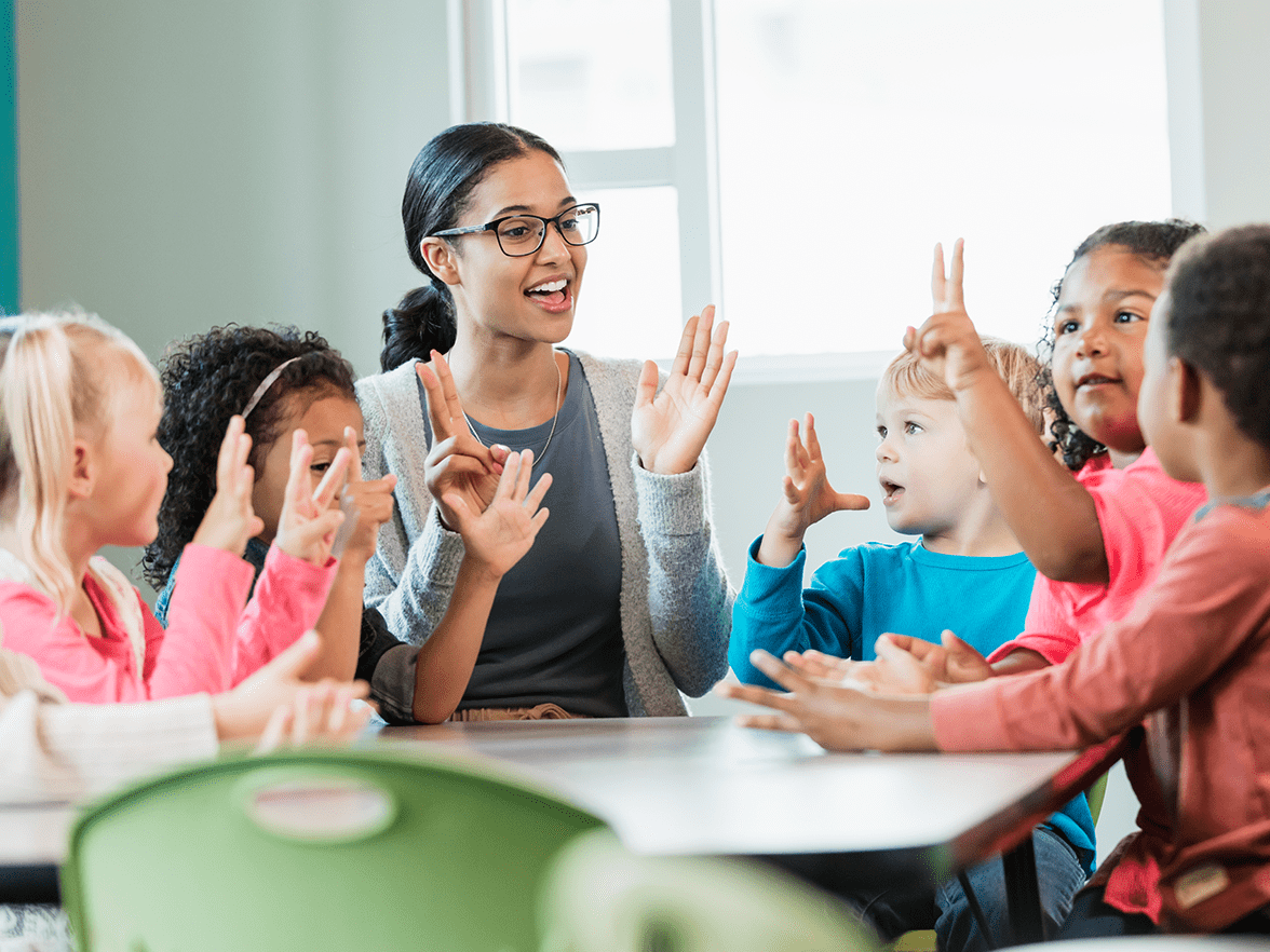 Caregiver playing with children at a center