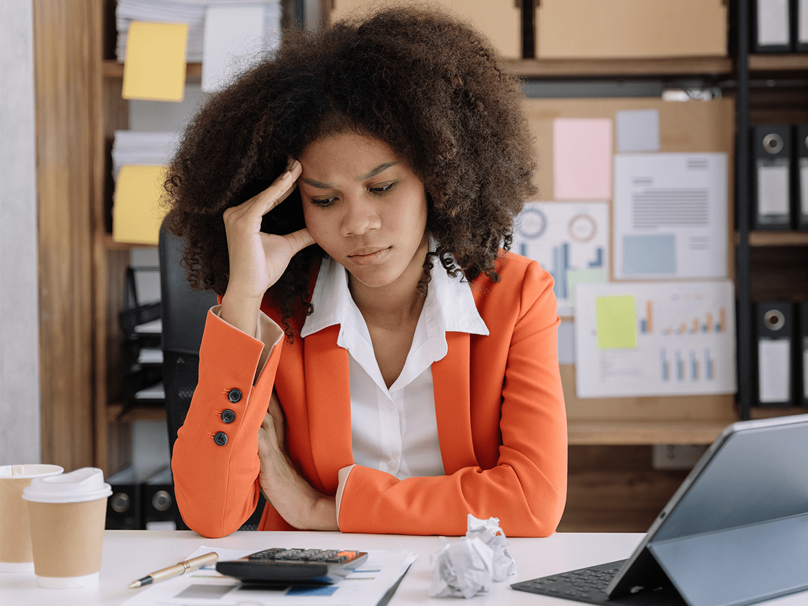 HR professional sitting at desk looking stressed