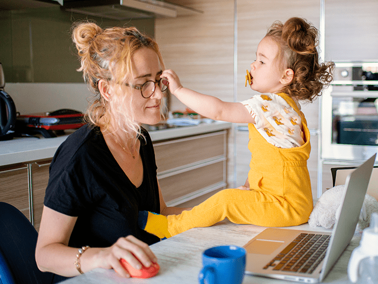 Mother and daughter playing in the kitchen in the morning