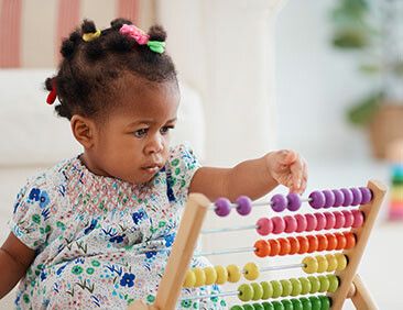 Baby playing with toys in a classroom