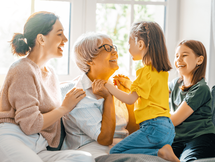 Grandmother with daughter and two granddaughters smiling