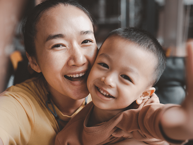 Mother and son smiling while taking a picture together