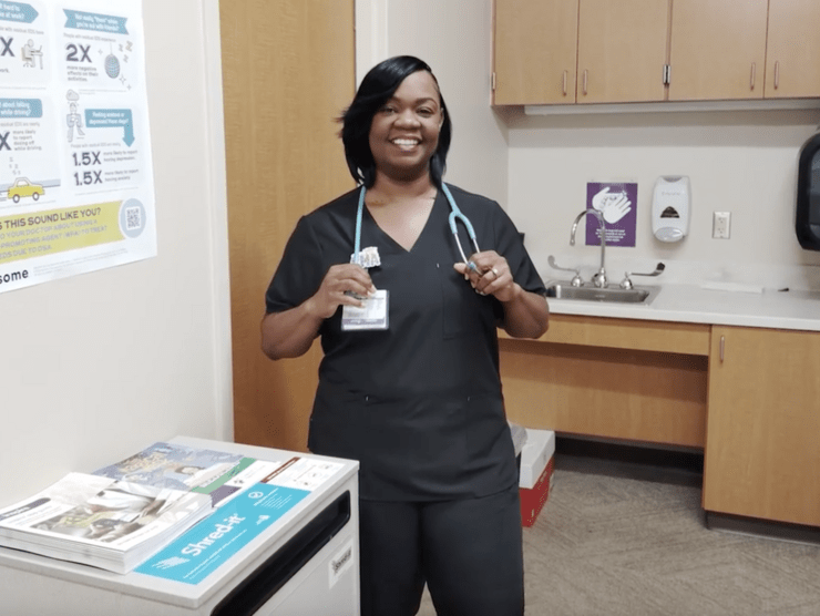 A nurse posing for a picture in a doctor's office