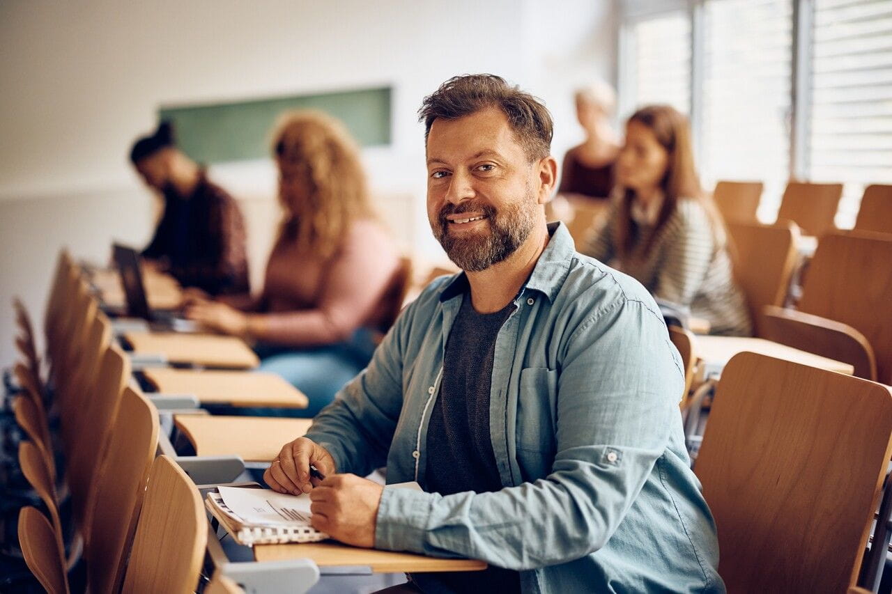 Man in a classroom doing schoolwork