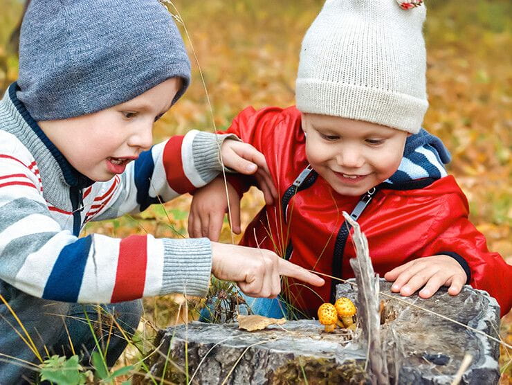 Preschoolers playing outside in the fall