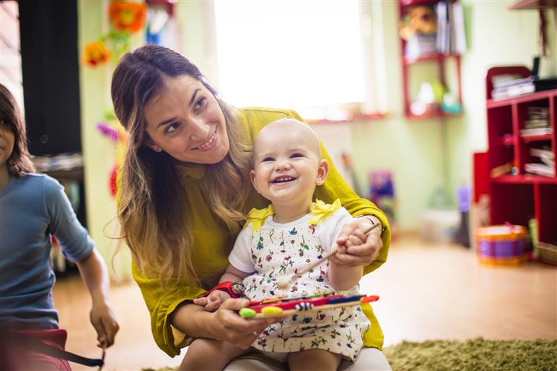 Teacher and child playing in a classroom