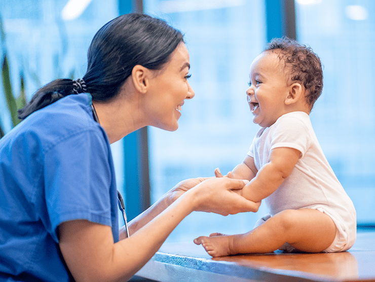 Healthcare worker playing with a baby