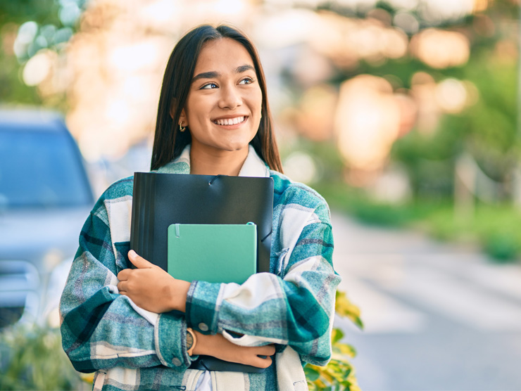 Hispanic student holding books