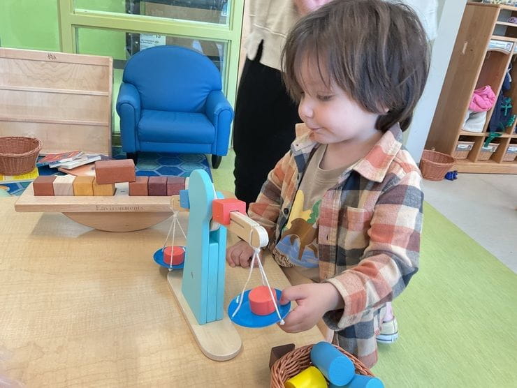 Child playing with a toy in a classroom