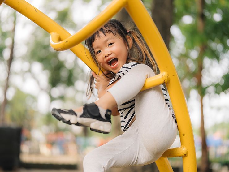 Young girl playing on a structure