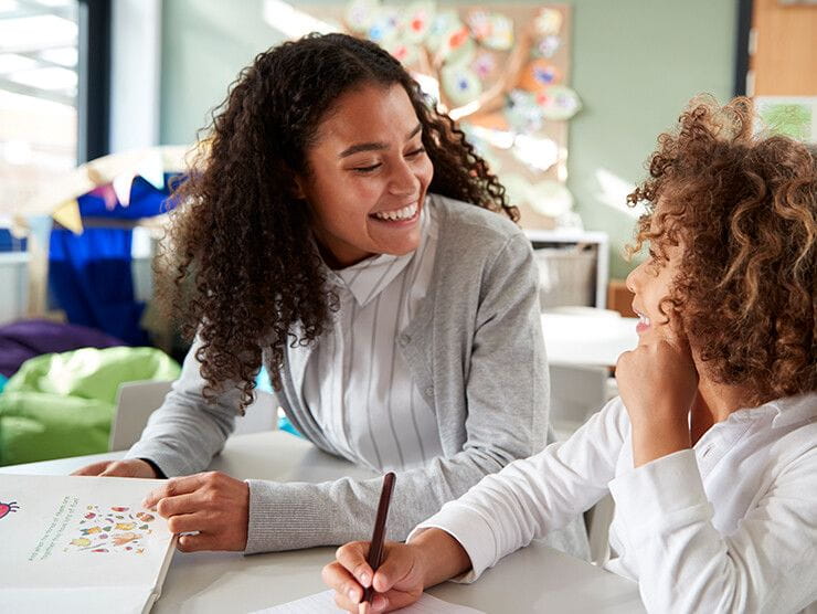 Mother and daughter working on schoolwork at the table