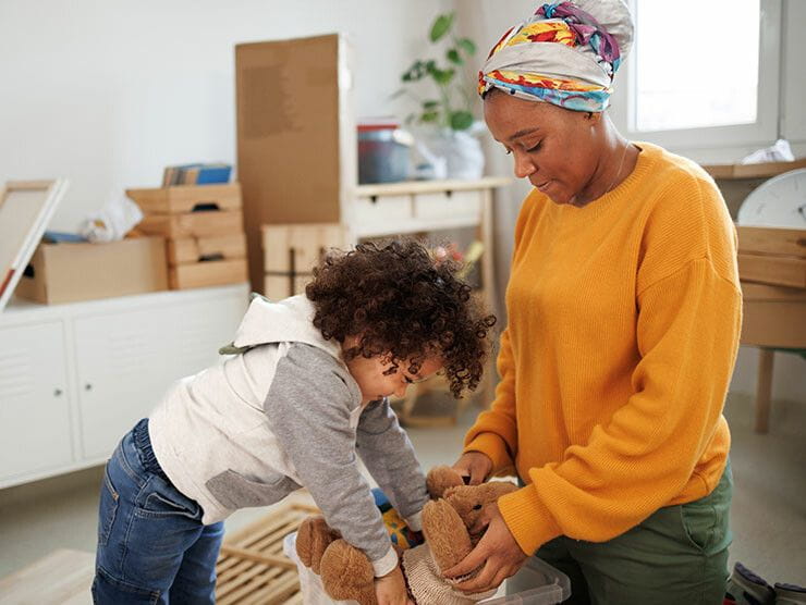 Mother and son organizing toys