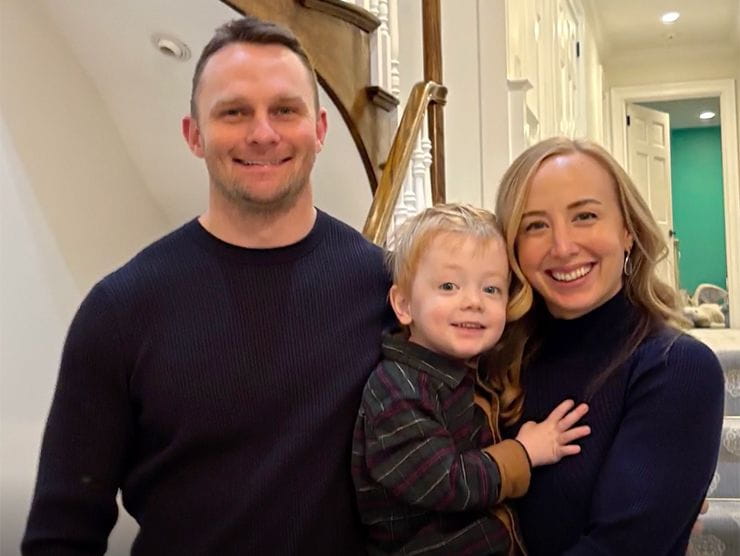 Family of three posing for a picture