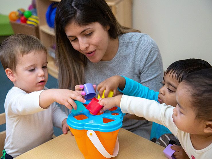 Teacher playing with students in a classroom