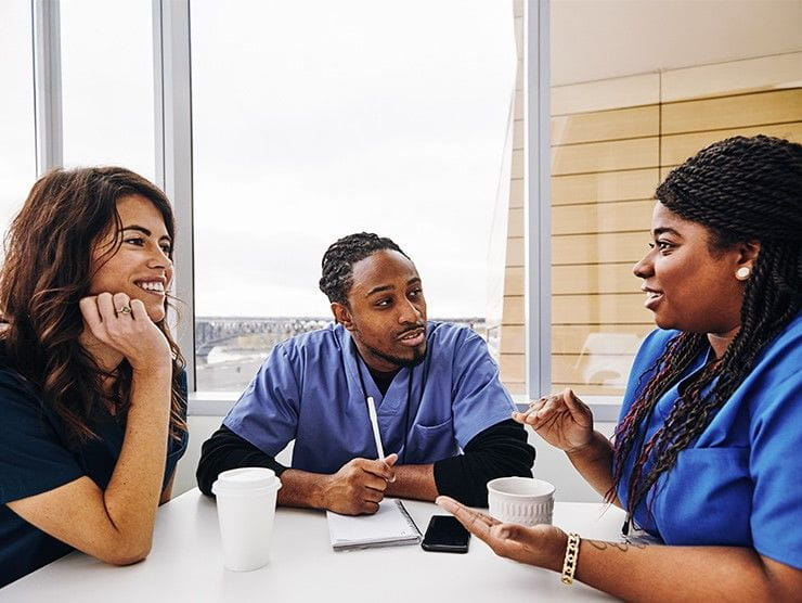 Nurses sitting at a table talking