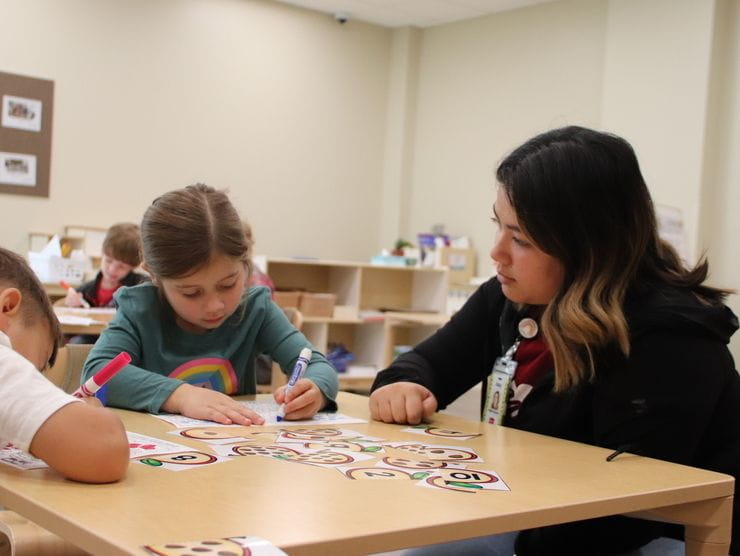 A teacher and student at an onsite child care center