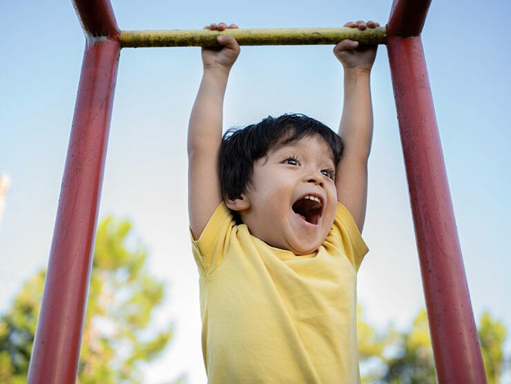 Boy playing outside on a structure