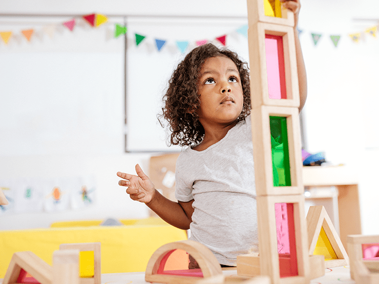 A child playing with toys in a classroom