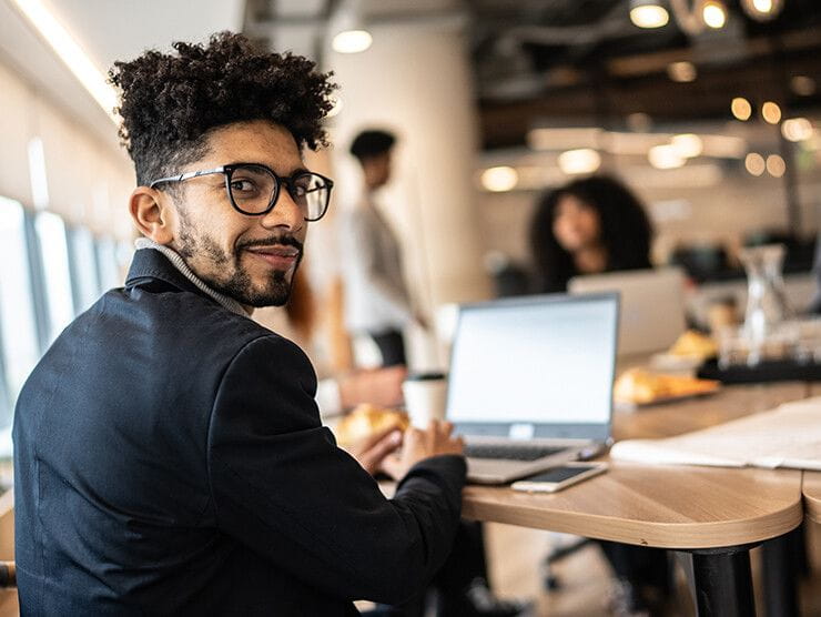 Man sitting at a table working on a computer