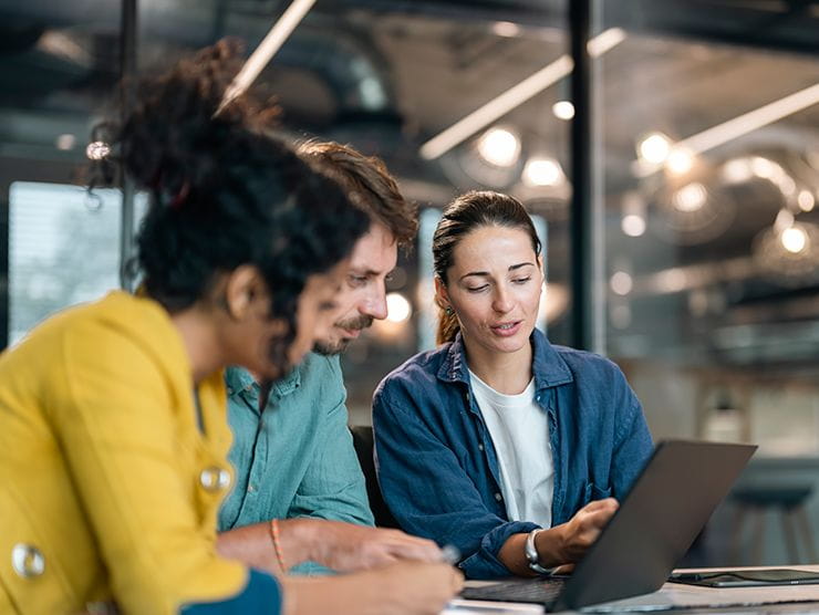 Three professionals working in an office