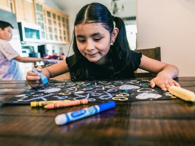 School-aged girl participating in arts & crafts