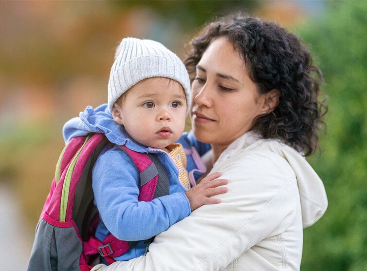 Mother holding a baby outside