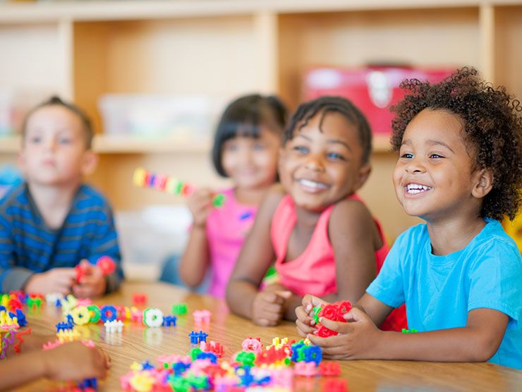 Preschoolers playing with toys in a classroom