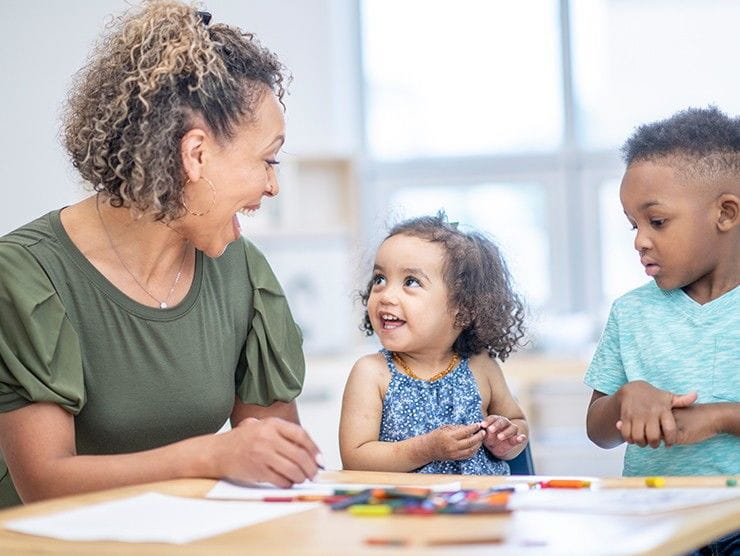 Teacher and children doing arts & crafts in a classroom