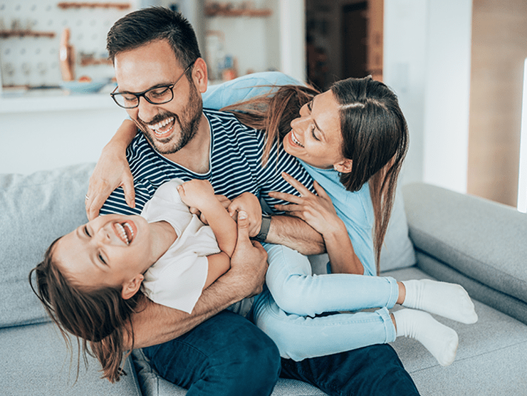 Mother and father playing with their daughter