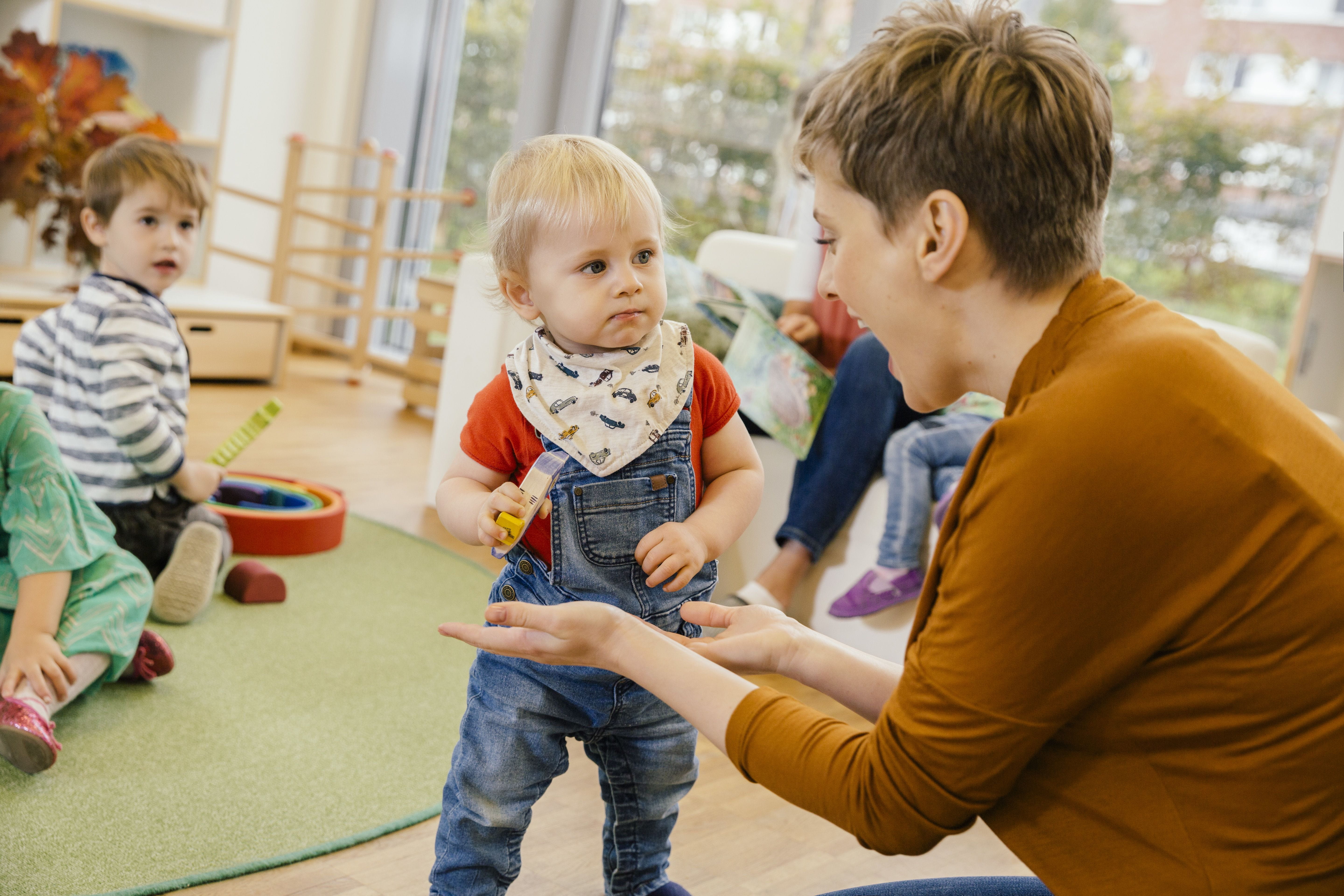 Teacher playing with students in a classroom