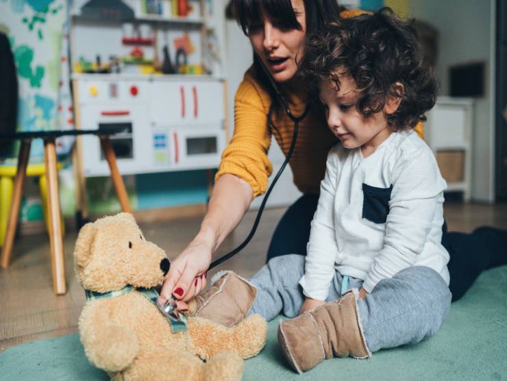 A young child playing with his caregiver