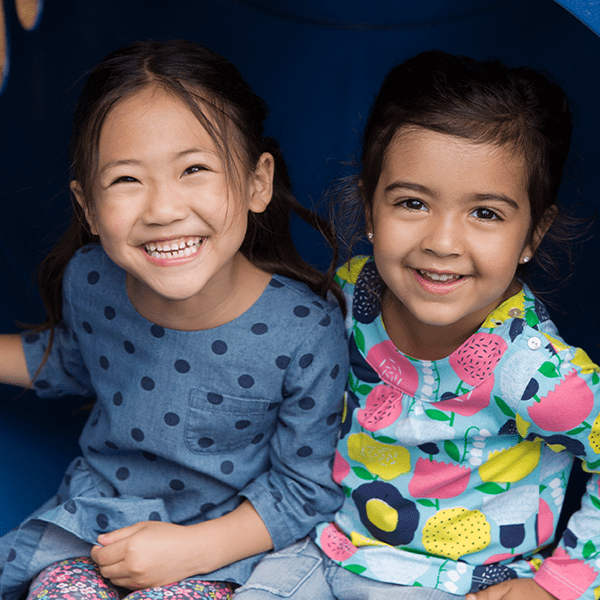 Two young girls smiling