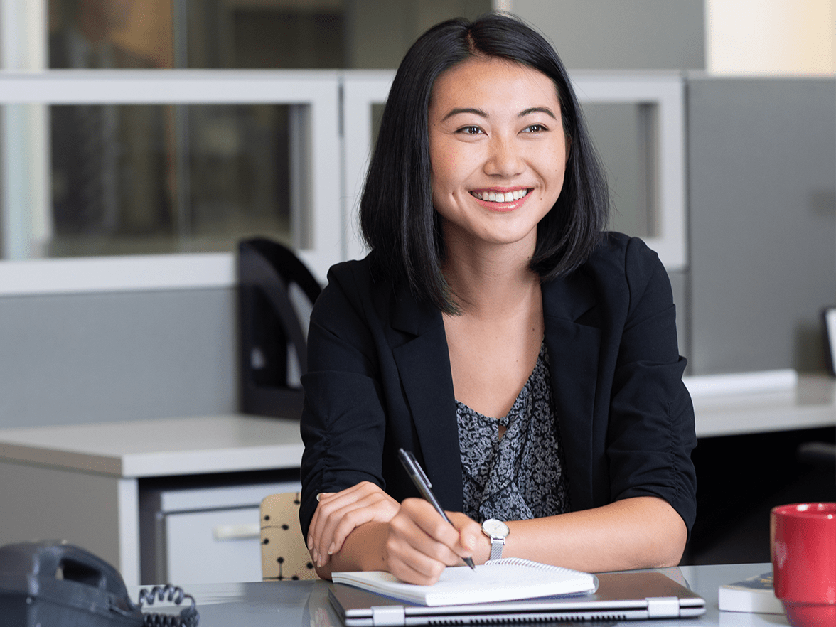A woman sitting at her office desk. 