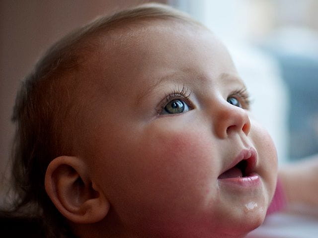 Smiling baby looking up