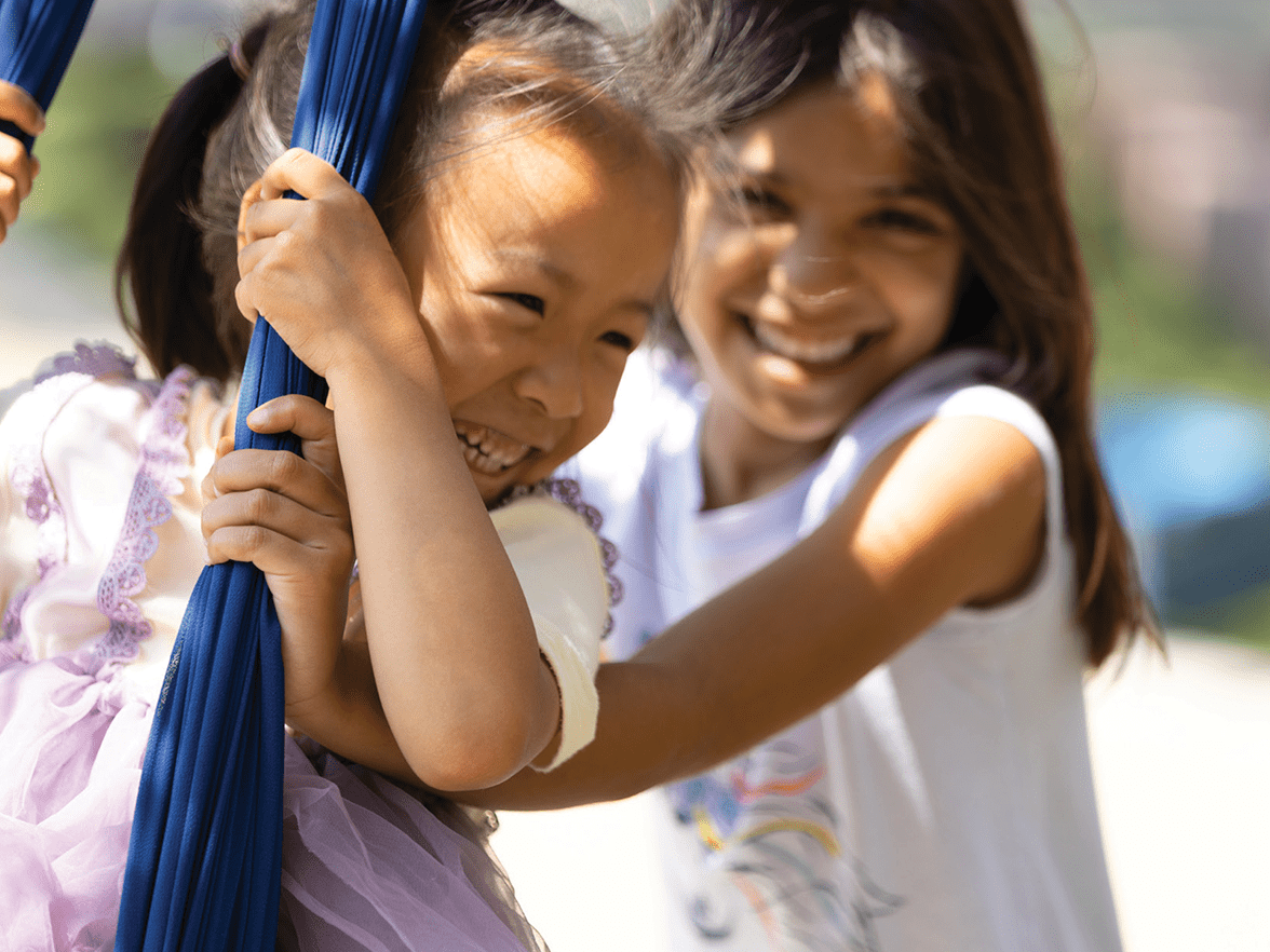 Two children playing on a playground