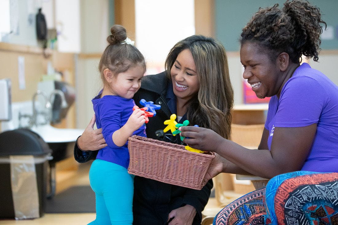 Teachers interacting with a child in a Bright Horizons center