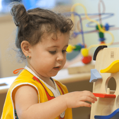Preschool child engaged in hands-on play activity that supports creativity, focus, and early learning development 