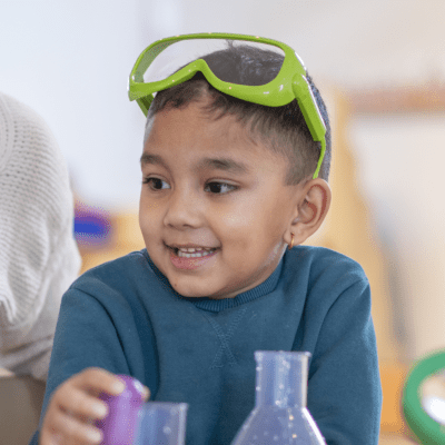 Child exploring materials during preschool science play activity that encourages curiosity, discovery, and active learning 