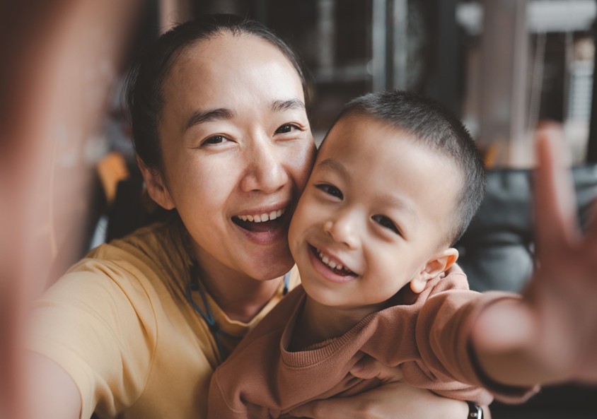 A woman smiling with an infant