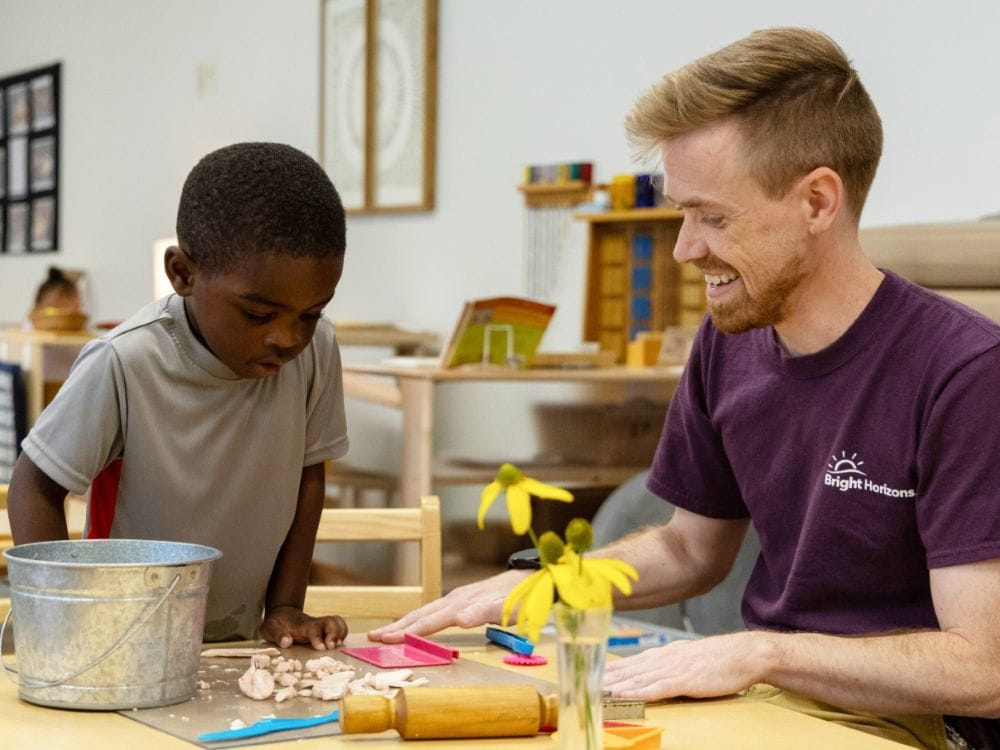 A teacher and child in a classroom. 