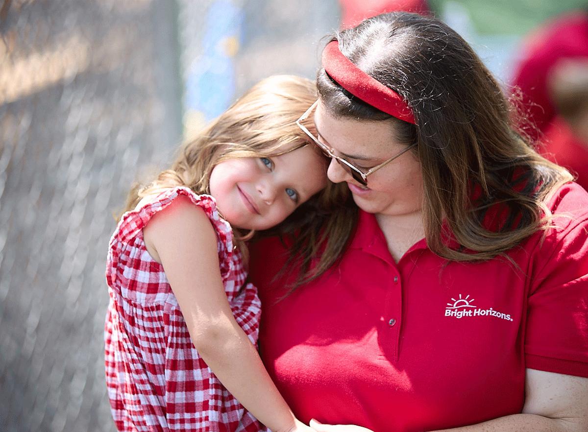 Young girl smiling with a teacher