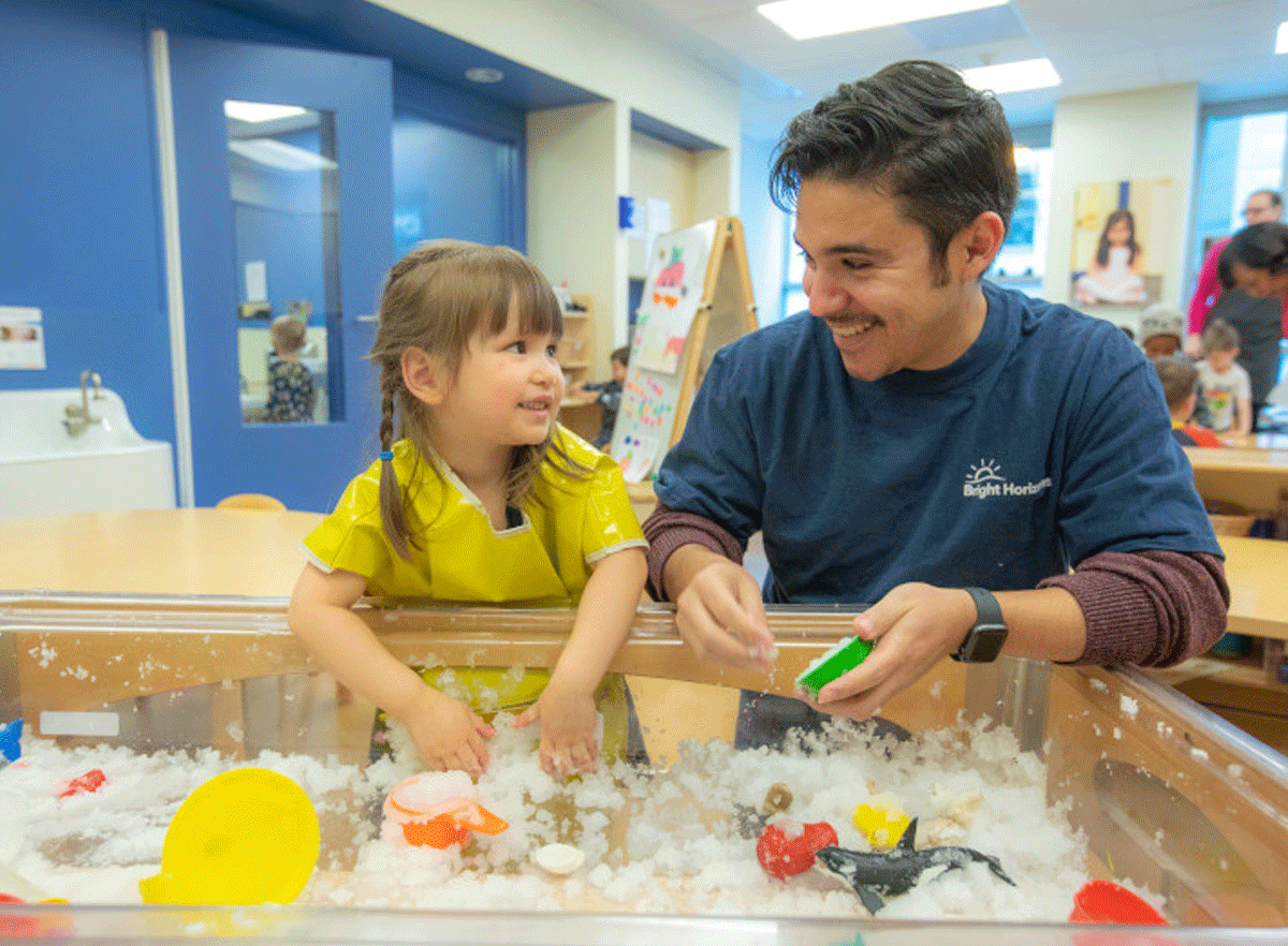 Teacher and student playing arts & crafts