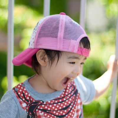 Toddler smiling outside during play that supports emotional growth and development 