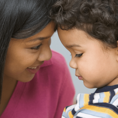 Mother and toddler sharing a smile during a positive parenting moment in the toddler years 