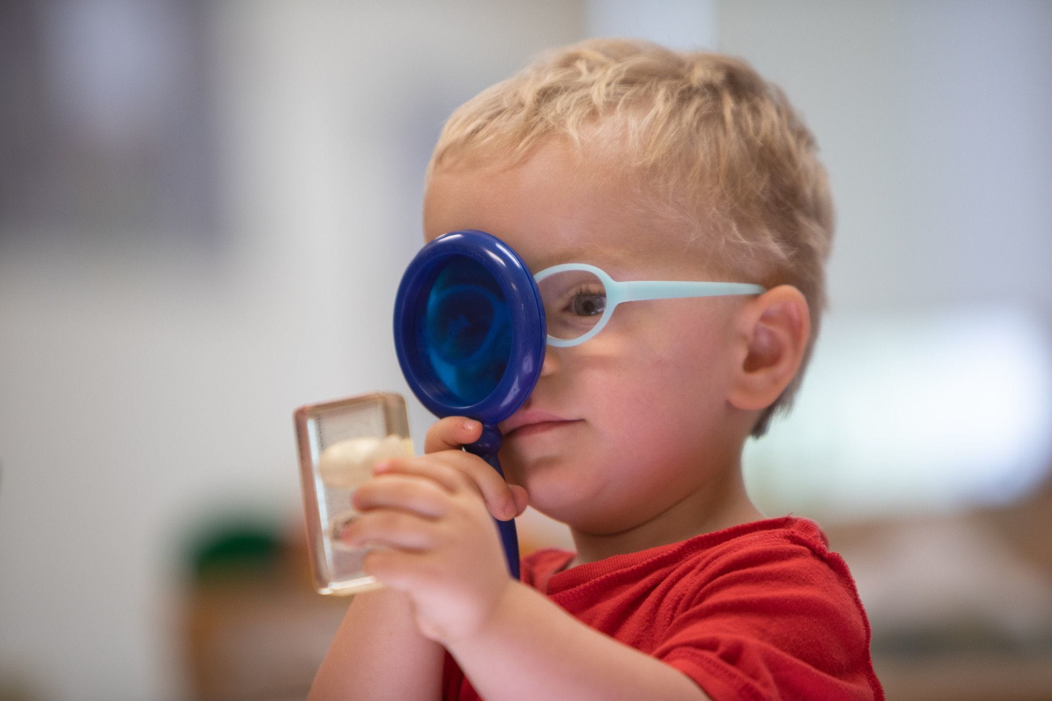 Child using magnifying glass