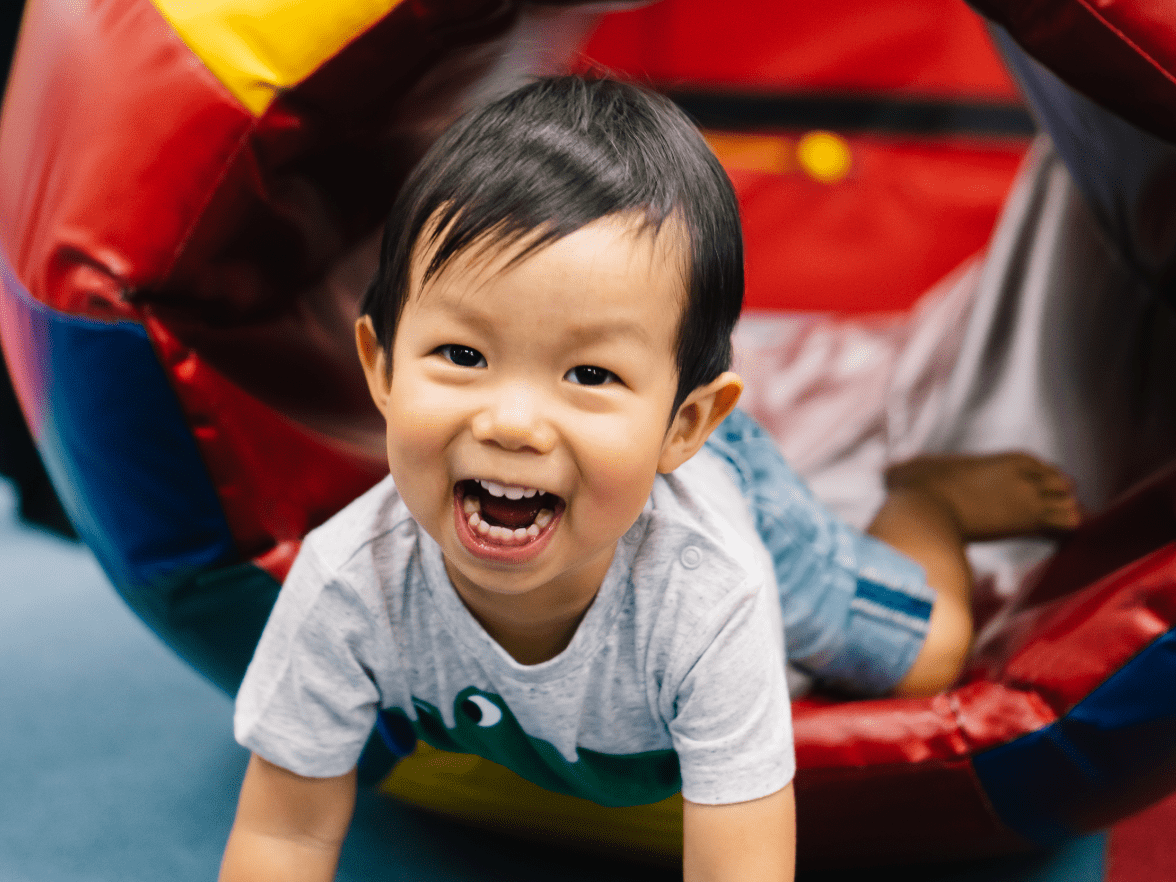 Young boy playing on a play structure