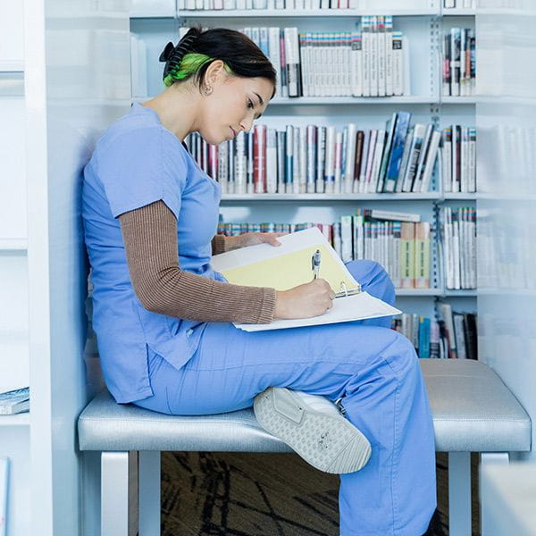 Healthcare professional working in library