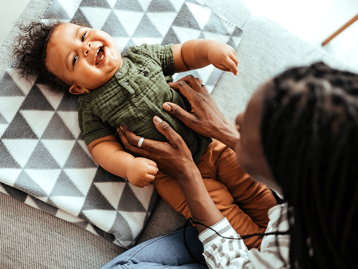 Mom playing with infant child