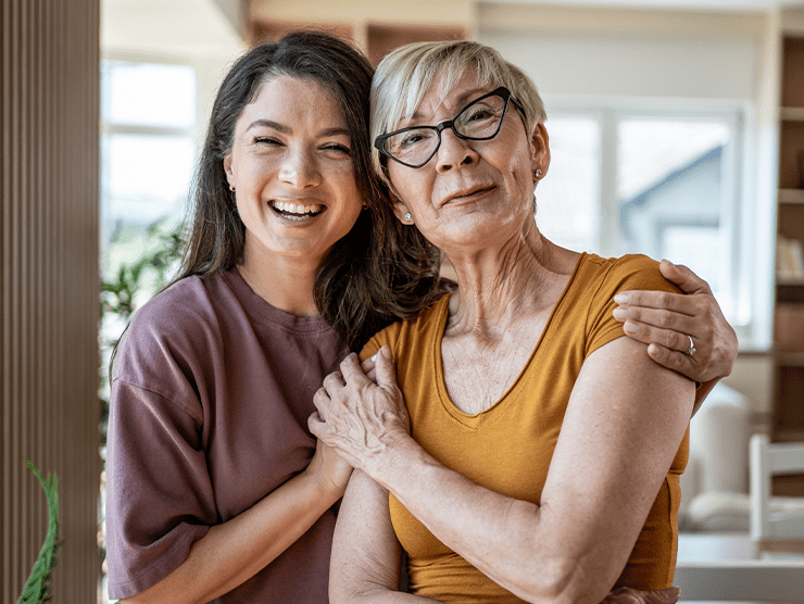 Mom and daughter while smiling.