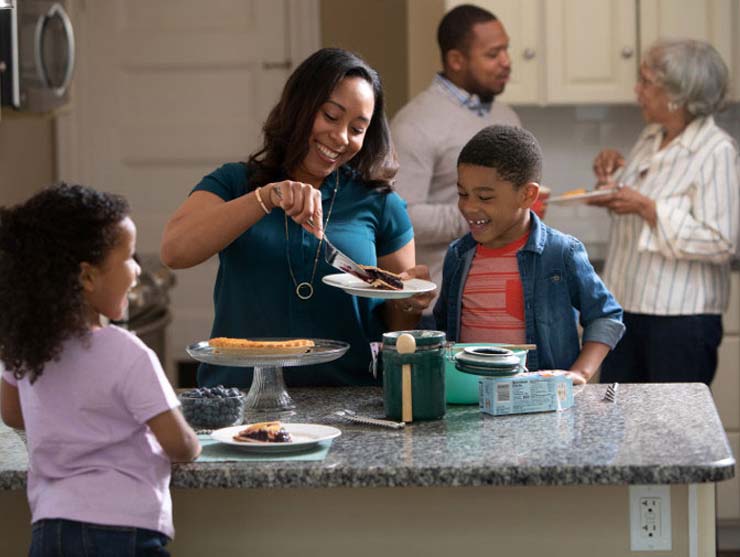 family doing a Thanksgiving activity in their kitchen at home